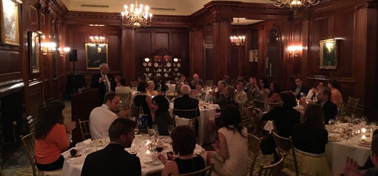 Members at dinner in a wood-paneled room