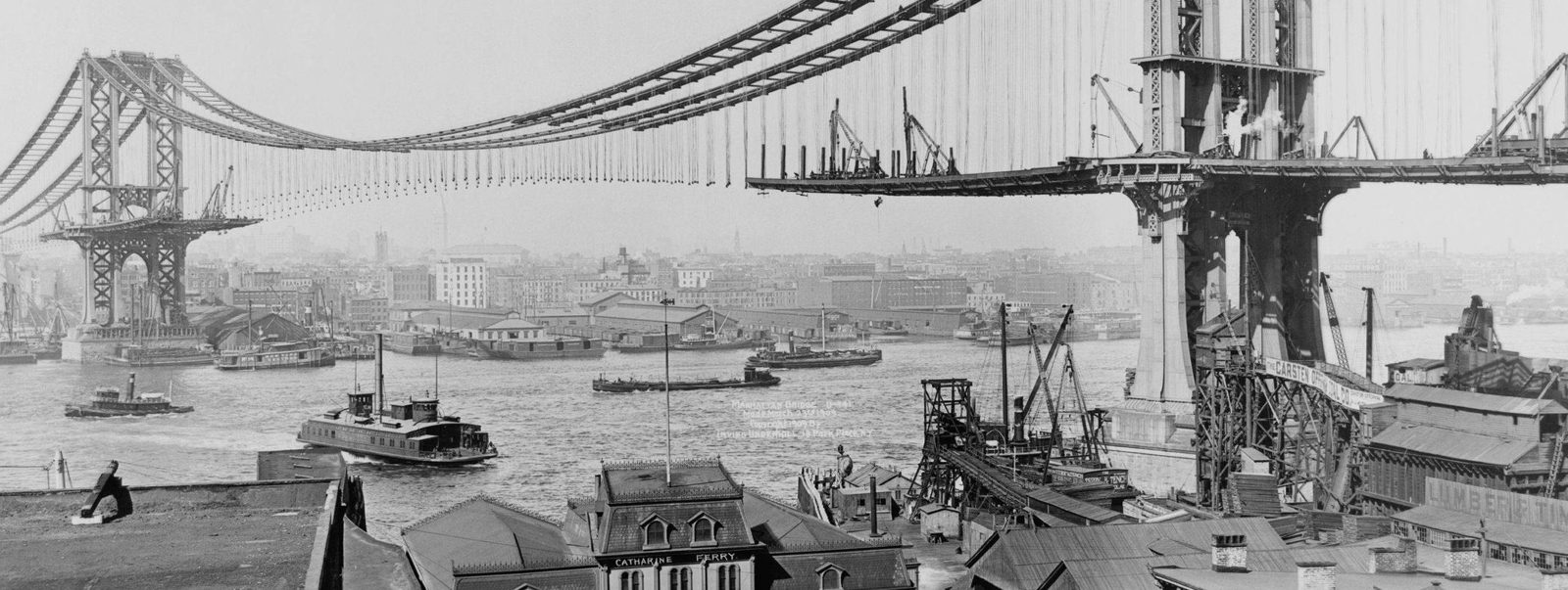 Historic photograph of the Manhattan Bridge under construction over the East River